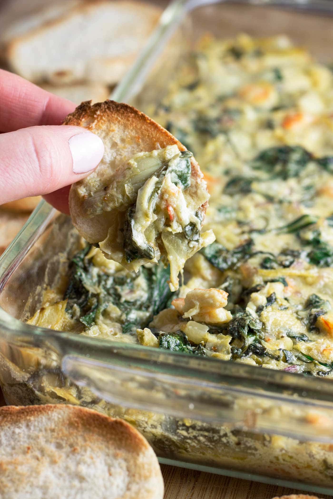 You won’t believe there’s no cheese in this delicious dip! Spinach artichoke dip made dairy free! Plus #shrimp! Y'all are going to love this easy and addictive recipe. With just 10 minutes of prep time it's perfect for #gameday! This simple recipe is #paleo #whole30 #lowcarb #keto #glutenfree and #dairyfree! #spinachartichokedip #paleoappetizer #whole30appetizer #gamedayrecipes #whole30recipes #healthyeating #artichokes #spinach #glutenfreeappetizer #Whole30gameday #paleogameday #healthypartyfood #dairyfreedip 