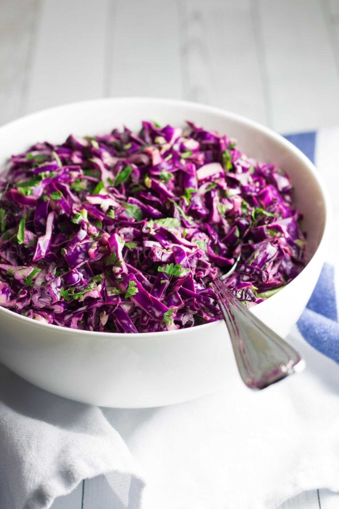Creamy, Tangy Purple Coleslaw - Flavorful and easy to make! This 10-minute healthy coleslaw recipe is perfect for tacos, pulled pork sandwiches, on top of a big salad, or as a side dish with any meal! This paleo coleslaw recipe is also gluten free, dairy free, Whole30 approved, low carb, and keto! This creamy dairy free coleslaw is perfect for your next party. Talk about a great Whole30 side dish! #paleo #whole30 #lowcarb #keto