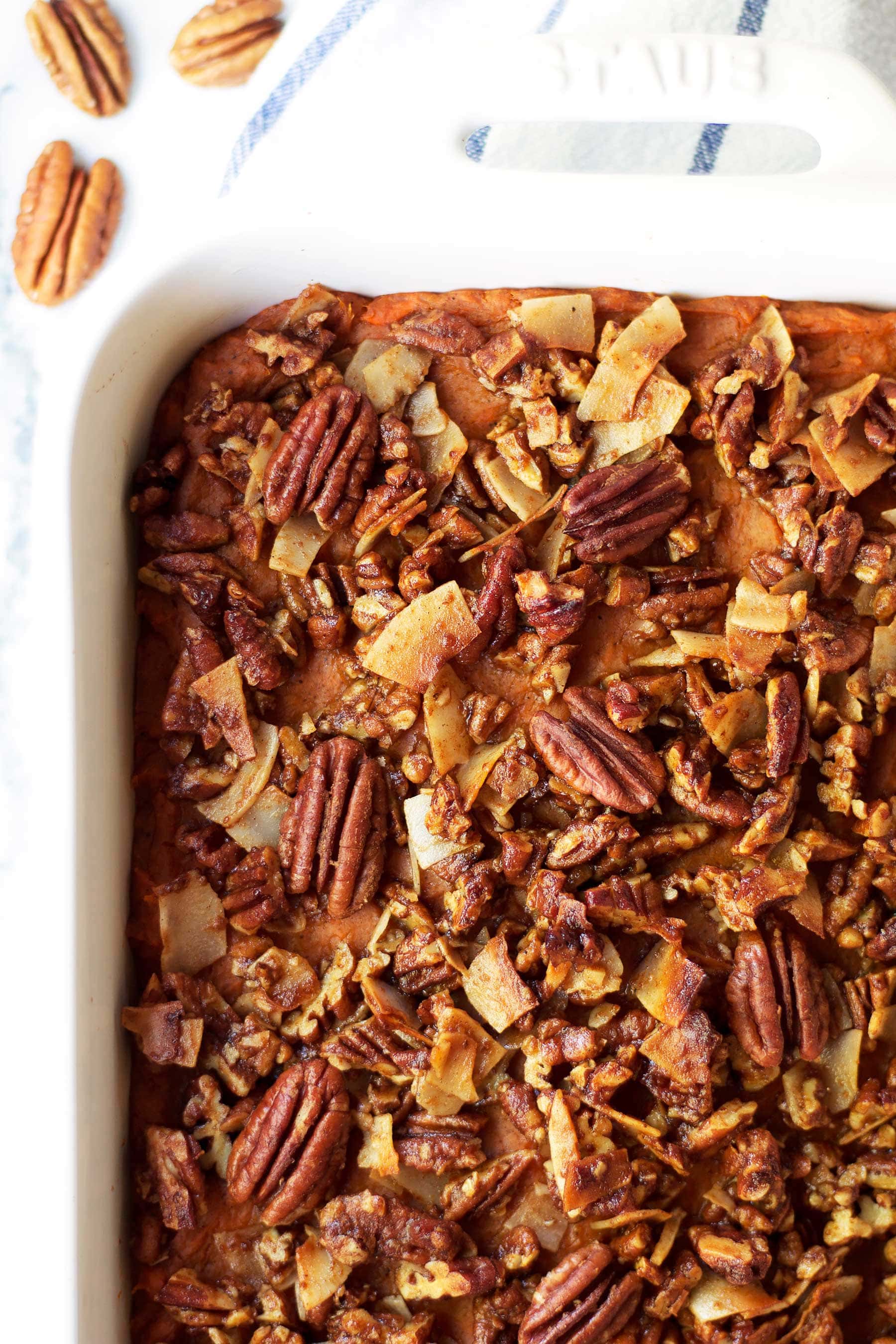 Pumpkin pie meets sweet potato casserole in this easy holiday side dish! This Pumpkin Pie Sweet Potato Casserole with Coconut Pecan Crumble is the perfect paleo Thanksgiving recipe. The perfect addition to you Thanksgiving and Christmas table. Healthy Thanksgiving side dish. Healthy Christmas side dish. Paleo Christmas recipe. #thanksgivingsidedish #healthythanksgiving #healthychristmas #sweetpotato #pumpkinpie #sweetpotatocasserole #yams #maplesyrup #pecans #coconut #glutenfreethanksgiving #glutenfree #dairyfree