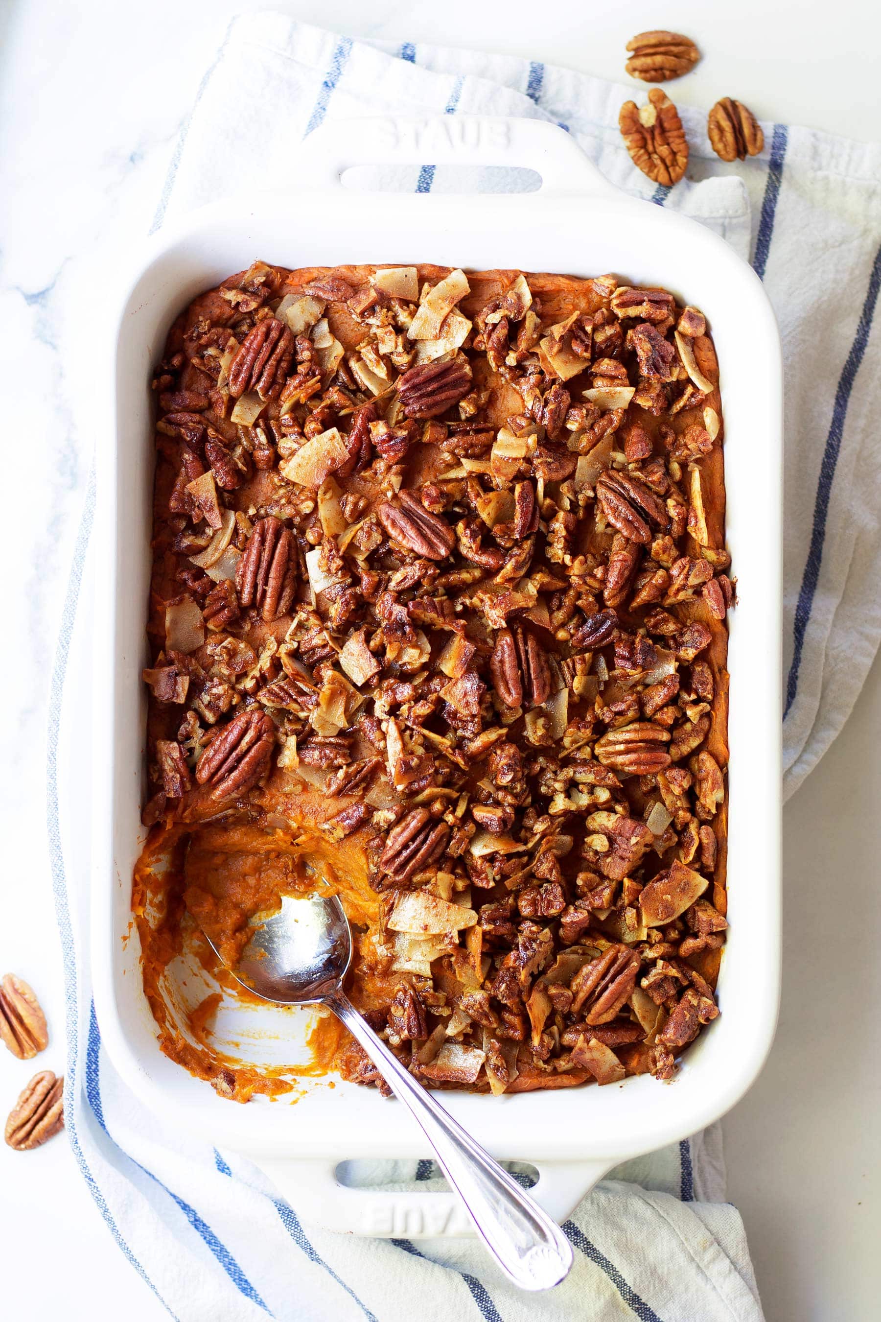 Pumpkin pie meets sweet potato casserole in this easy holiday side dish! This Pumpkin Pie Sweet Potato Casserole with Coconut Pecan Crumble is the perfect paleo Thanksgiving recipe. The perfect addition to you Thanksgiving and Christmas table. Healthy Thanksgiving side dish. Healthy Christmas side dish. Paleo Christmas recipe. #thanksgivingsidedish #healthythanksgiving #healthychristmas #sweetpotato #pumpkinpie #sweetpotatocasserole #yams #maplesyrup #pecans #coconut #glutenfreethanksgiving #glutenfree #dairyfree
