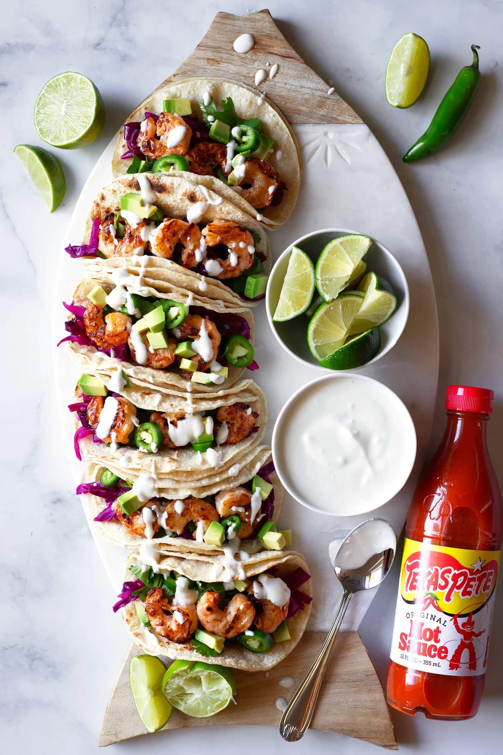 Only 30 minutes to make these easy shrimp tacos! #ad These grilled buffalo shrimp tacos are so flavorful, have the perfect crunch from the simple red cabbage slaw, and are topped with a creamy blue cheese crema! So good and perfect for summer! This recipe is gluten free and can be made low carb and keto by using a keto tortilla! #SauceIntoSummer #SauceLikeYouMeanIt #TexasPete #glutenfree #shrimptacos #shrimprecipes #easydinner #healthydinner #spicyshrimp #glutenfreedinner #weeknightdinner