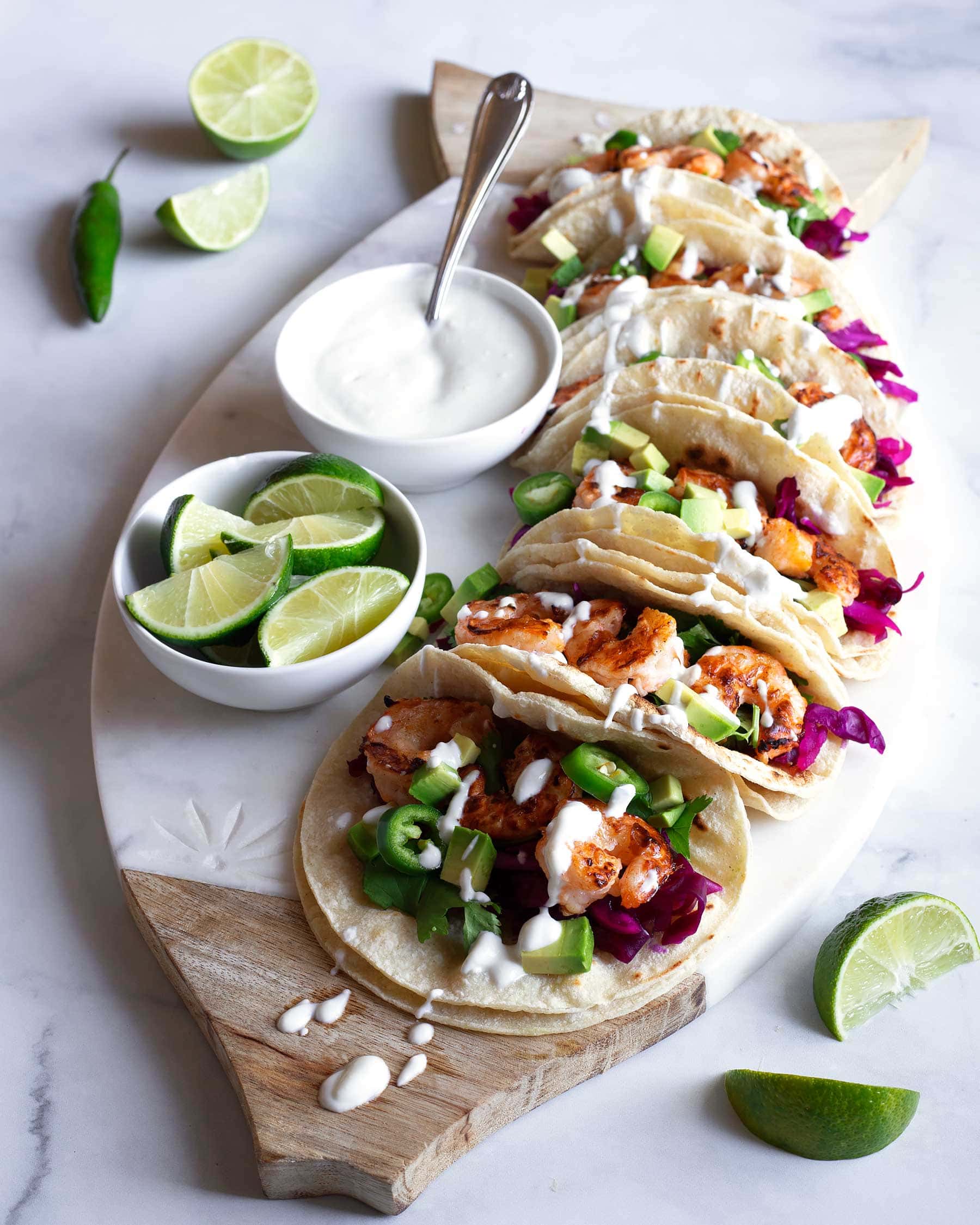 Only 30 minutes to make these easy shrimp tacos! #ad These grilled buffalo shrimp tacos are so flavorful, have the perfect crunch from the simple red cabbage slaw, and are topped with a creamy blue cheese crema! So good and perfect for summer! This recipe is gluten free and can be made low carb and keto by using a keto tortilla! #SauceIntoSummer #SauceLikeYouMeanIt #TexasPete #glutenfree #shrimptacos #shrimprecipes #easydinner #healthydinner #spicyshrimp #glutenfreedinner #weeknightdinner
