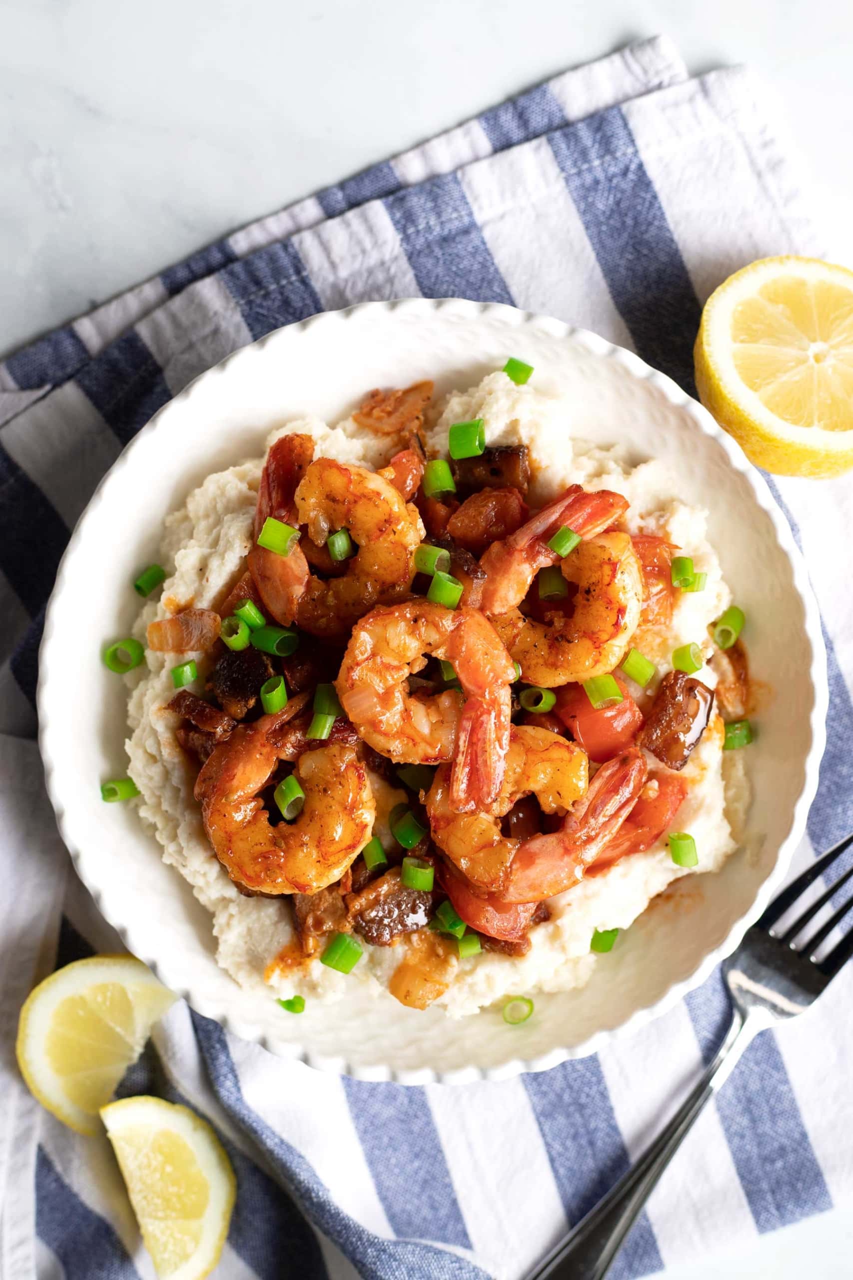 Keto Shrimp and Grits with lemon on the side and fork