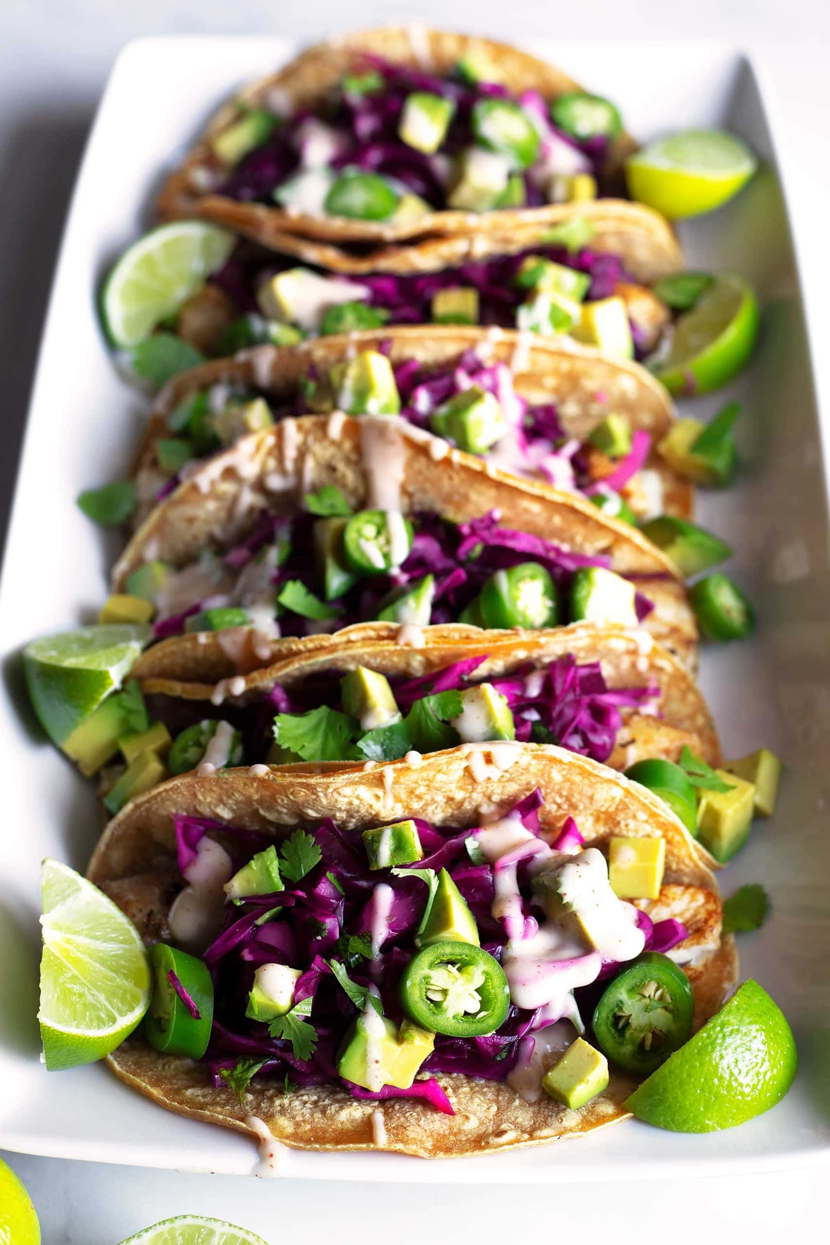 closeup photo of Baja Fish Tacos on a white serving plate