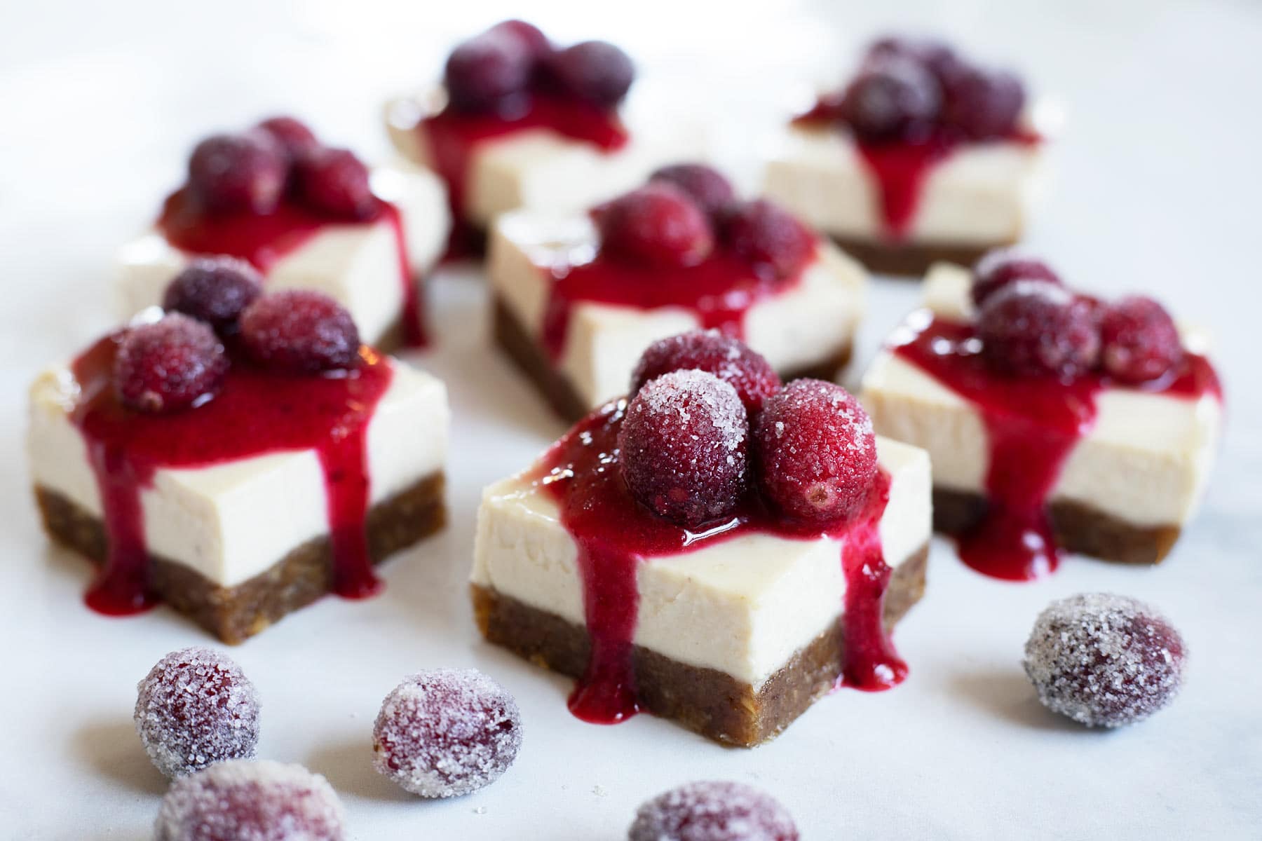 slices of No-Bake Christmas Cheesecake Bars with cranberries