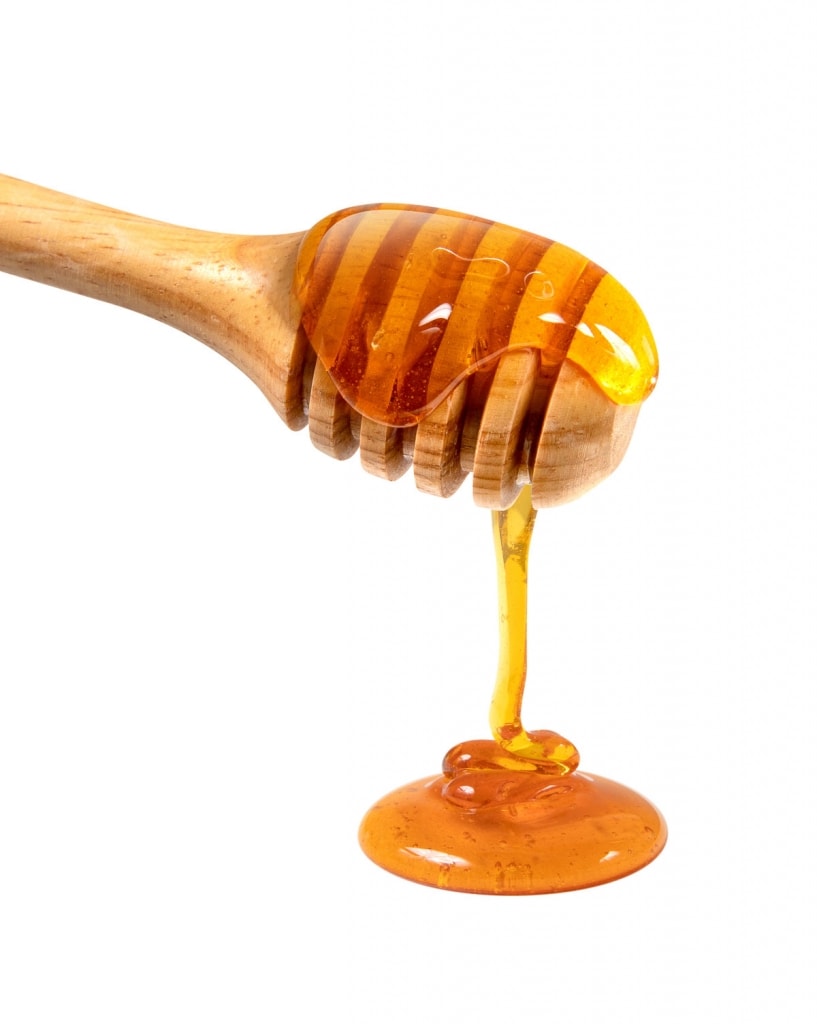 honey on wooden stick is a Healthy alternative to sugar 