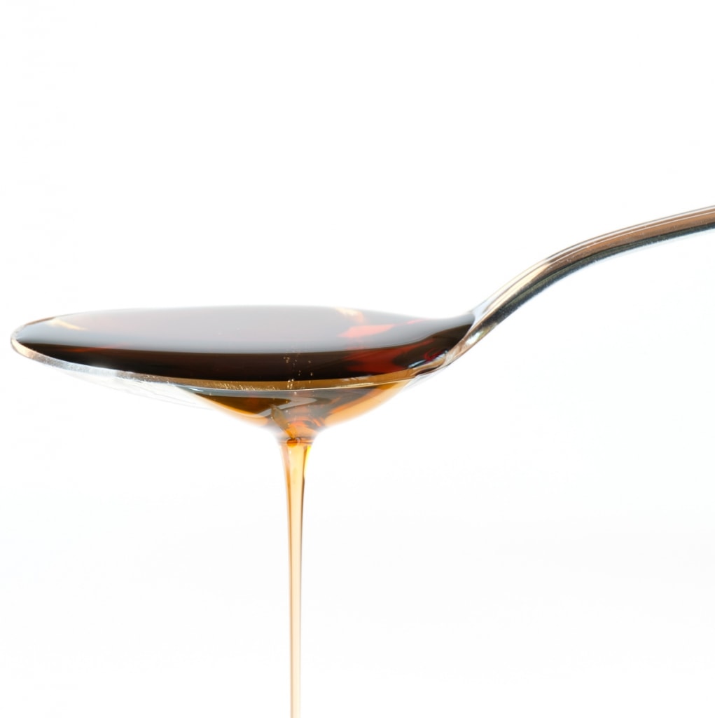 Maple Syrup Overflowing Off Spoon a Healthy Alternatives to Sugar in coffee
