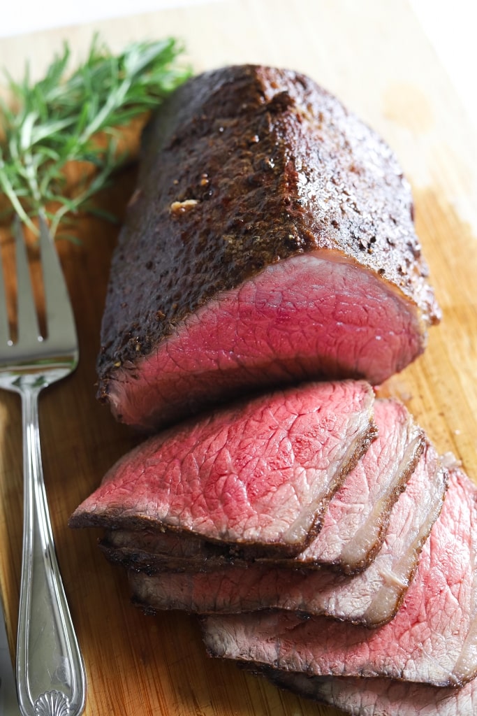 roast beef sliced on cutting board, how to cook melt in the mouth roast beef