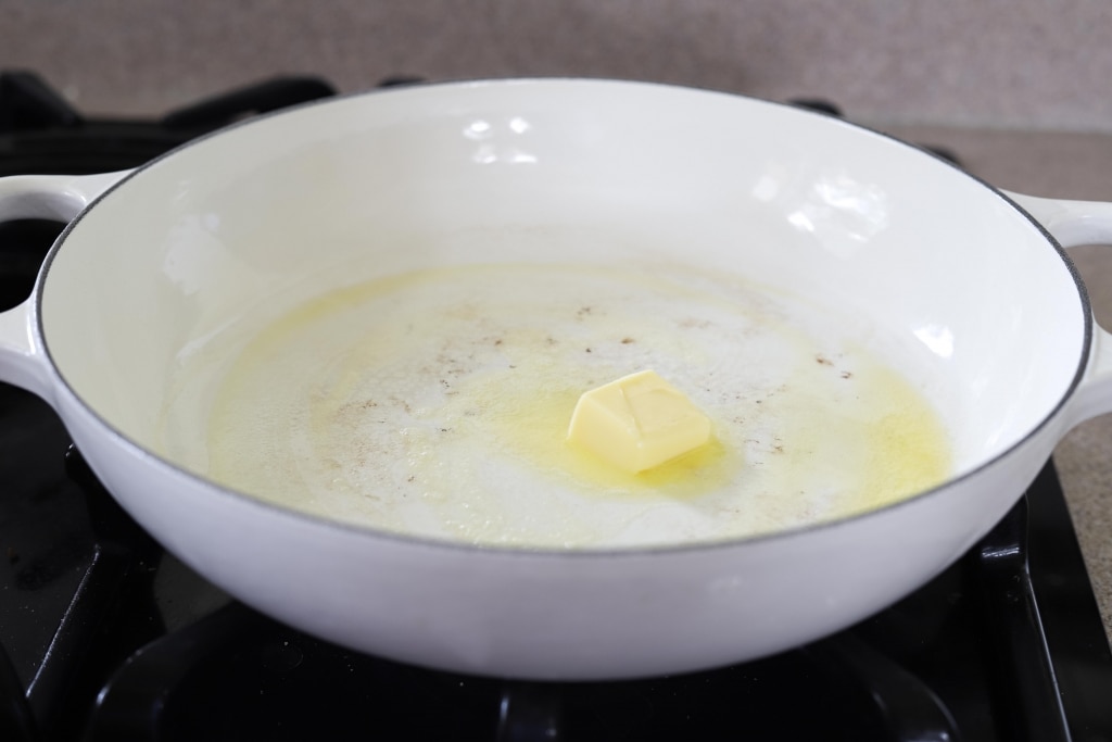 butter melting in white pan
