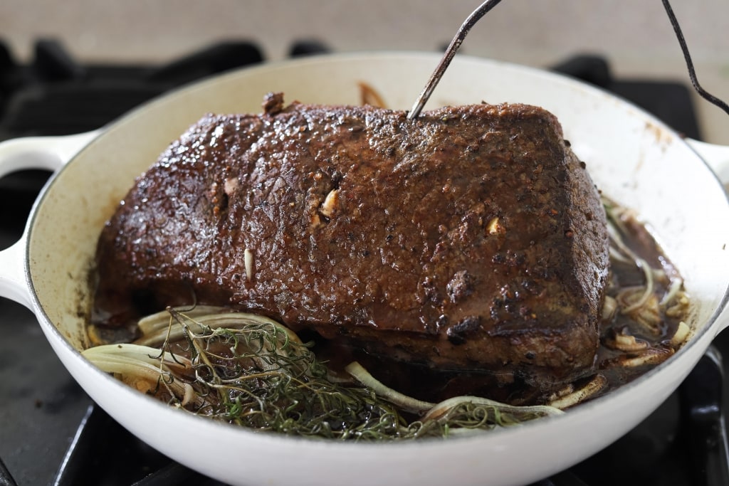 roast beef in braising pan after cooking