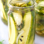 cucumbers in jars on white countertop