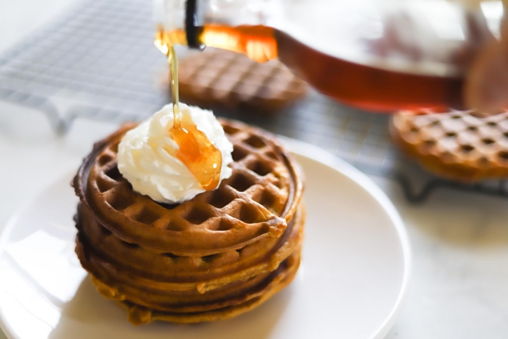 gluten free pumpkin waffle recipe - pouring syrup on waffles