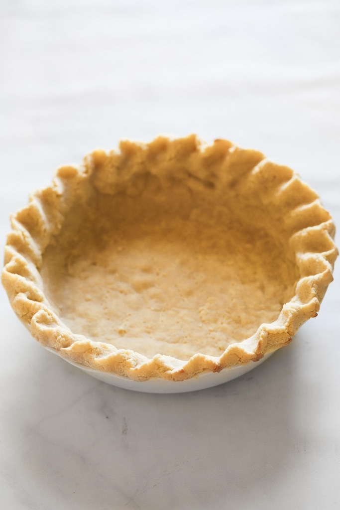 baked pie crust in white pie pan