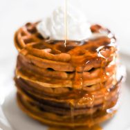 Gluten Free Pumpkin Waffles with syrup being poured on