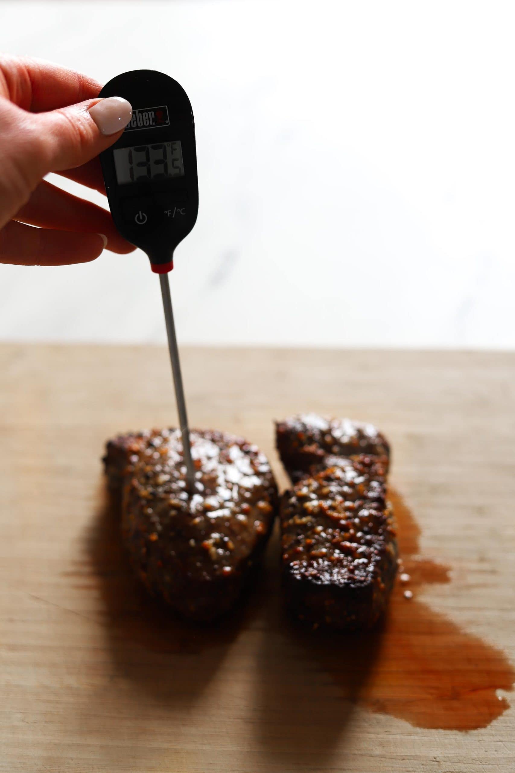 steak with meat thermometer checking temperature