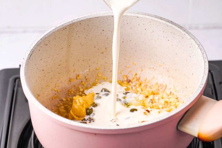 pouring cream into saucepan