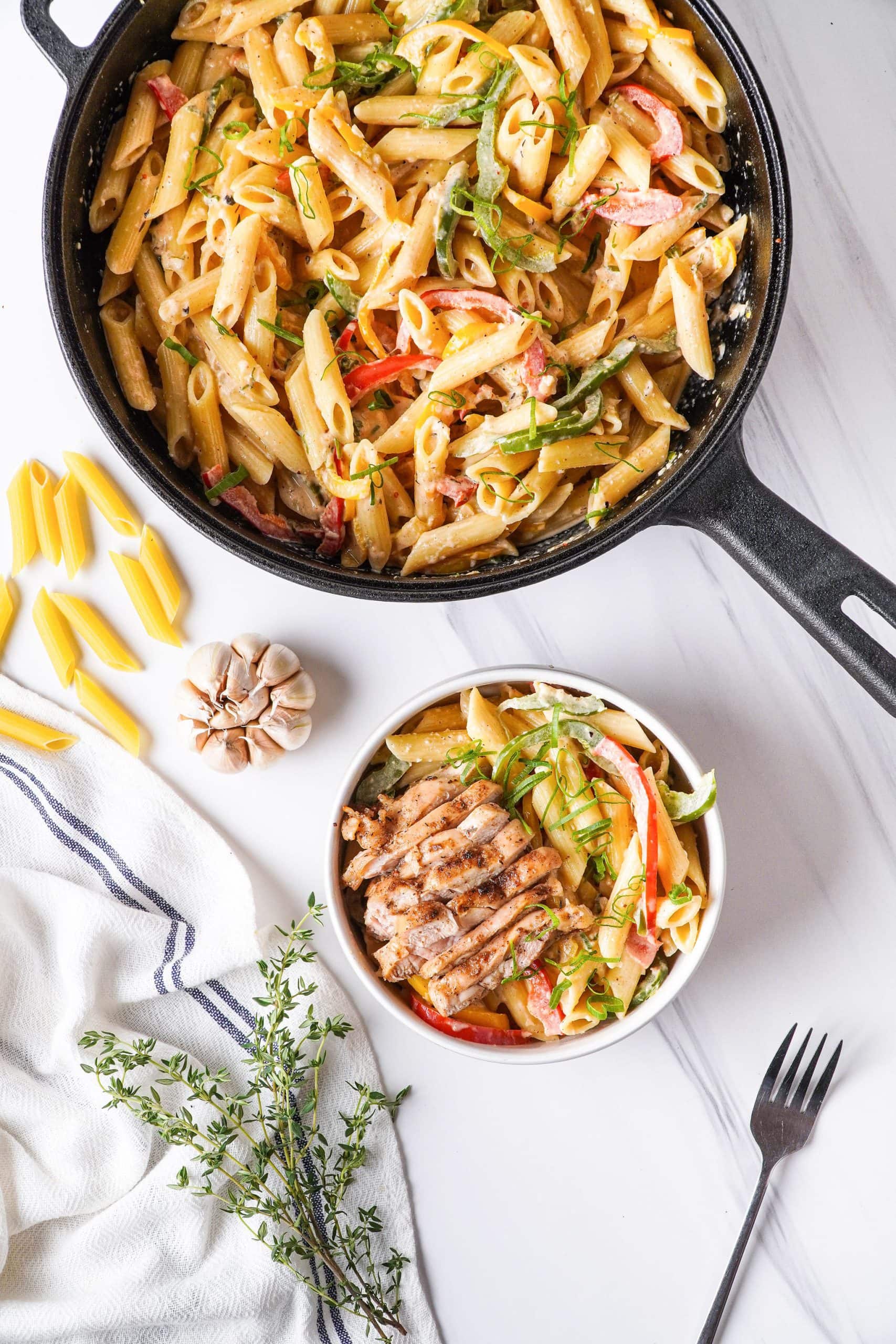 rasta pasta in skillet and in serving bowl