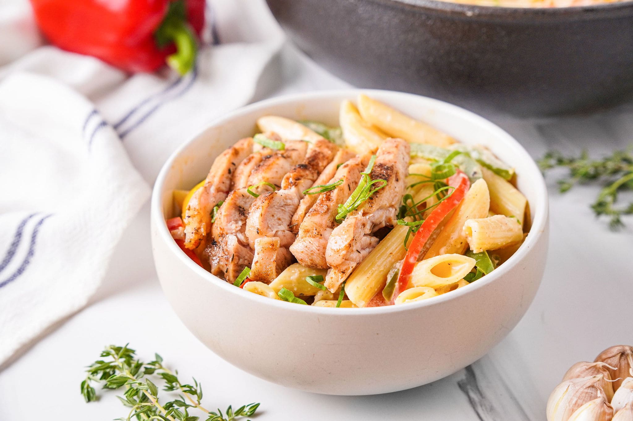 pasta in bowl with chicken on top
