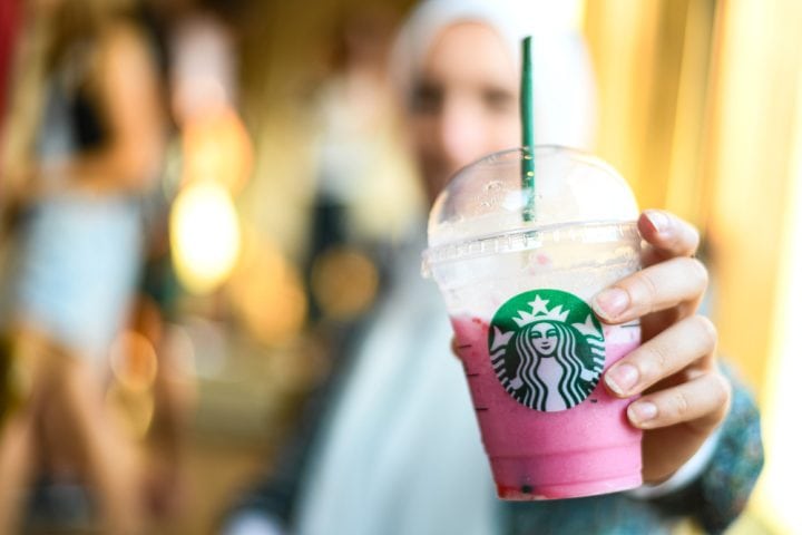 woman holding Starbucks pink drink