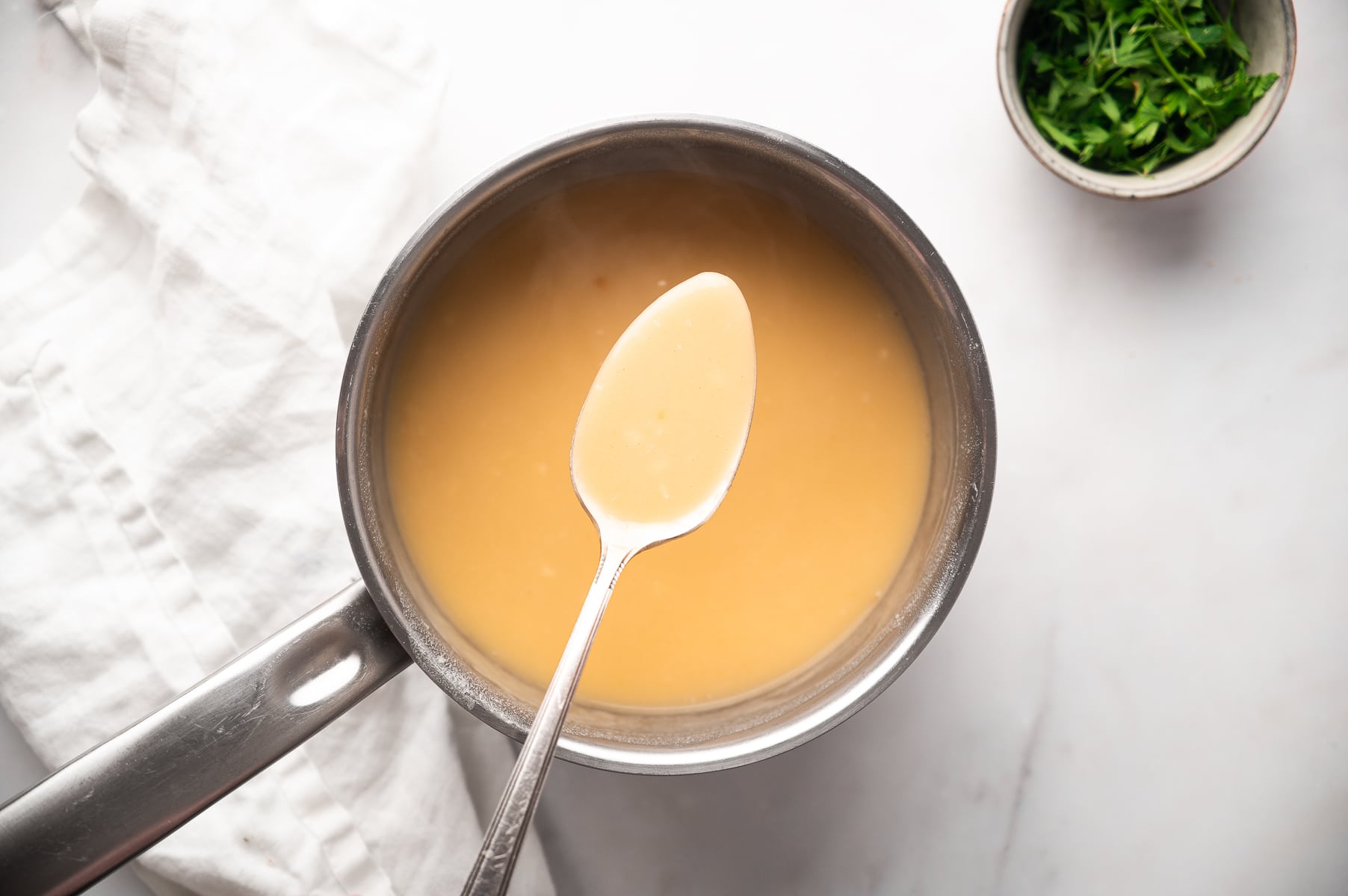 spoon showing gravy in pot