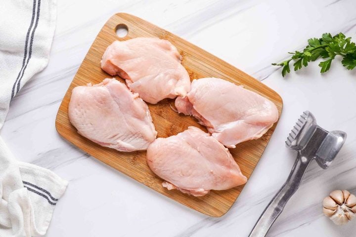 chicken breasts on cutting board