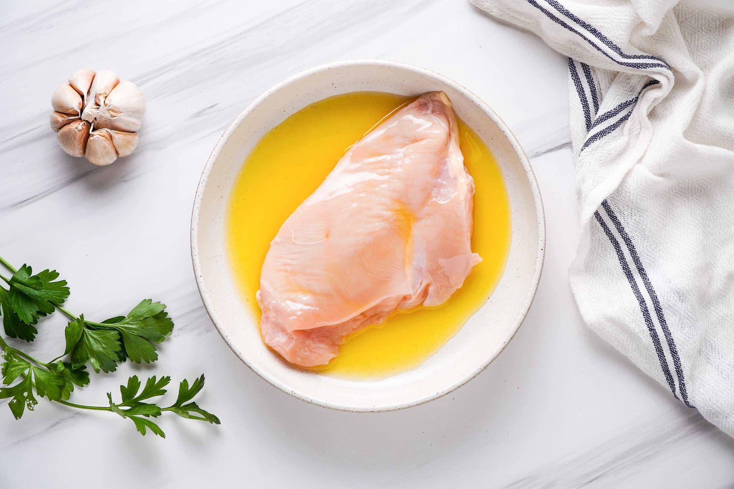 raw chicken breast dipped in melted butter