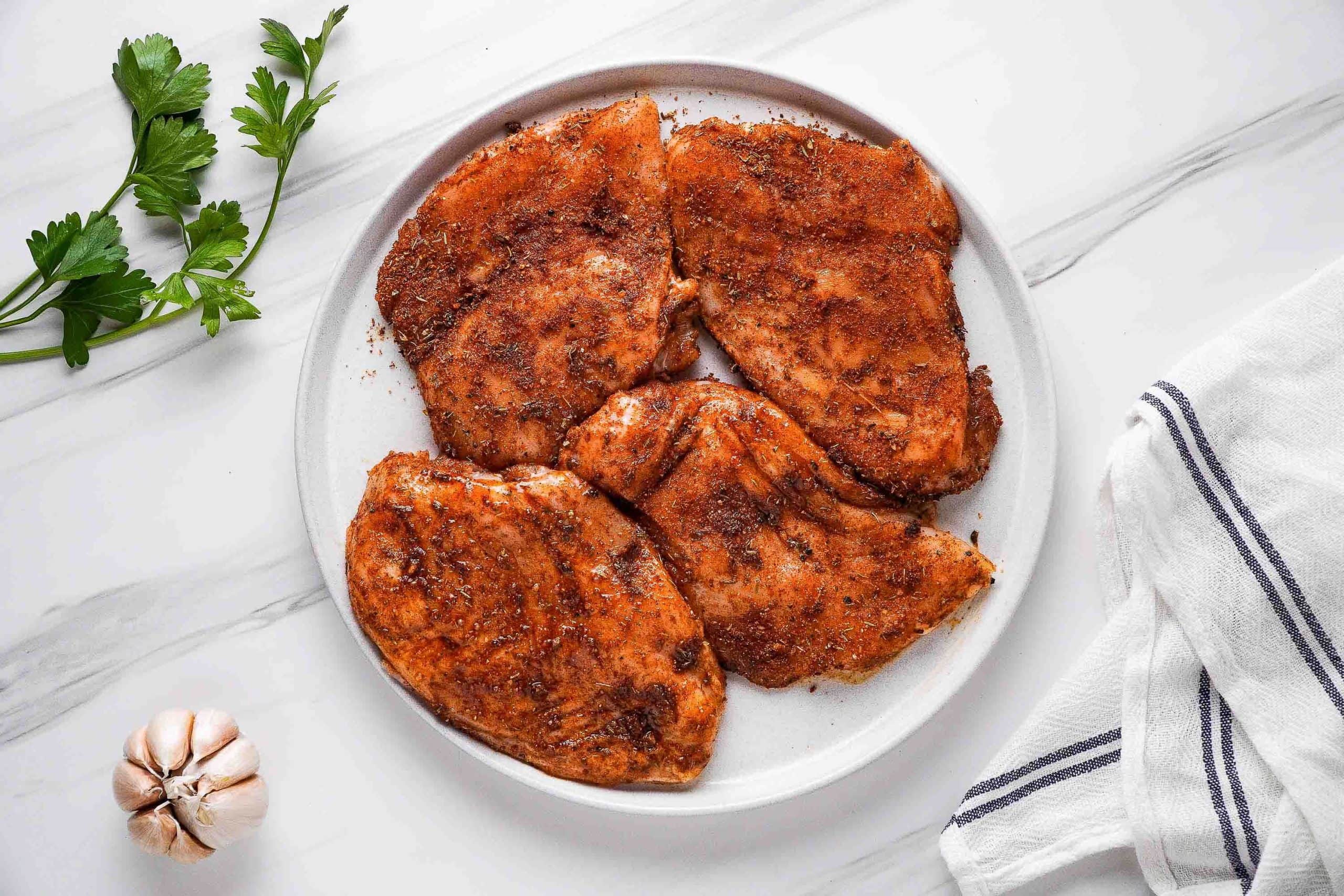 raw chicken breasts coated in blackened seasoning mix