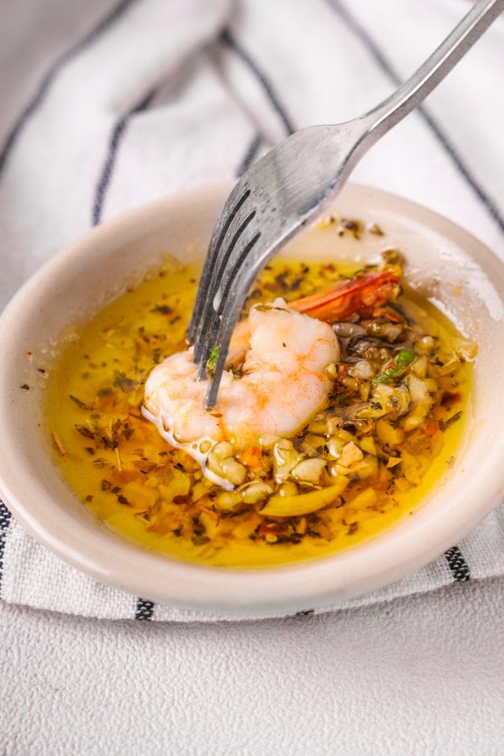 shrimp dipped in garlic butter with fork