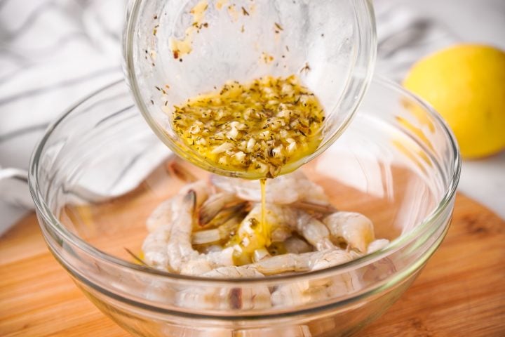 pouring garlic butter on shrimp